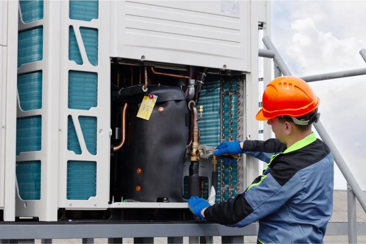 worker repairing industrial airconditioner