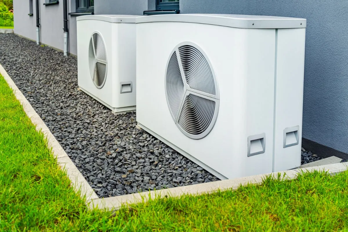 two air source heat pumps installed outside modern house