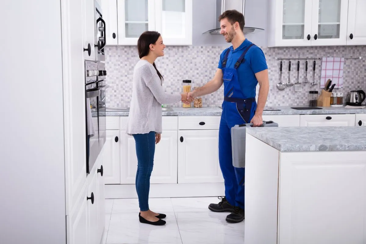 plumber shaking hands with client